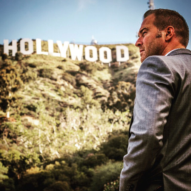 Justin Pearson next to Hollywood sign